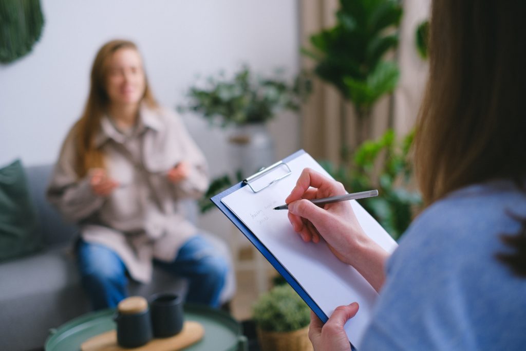 Recovery Worker taking notes with a client