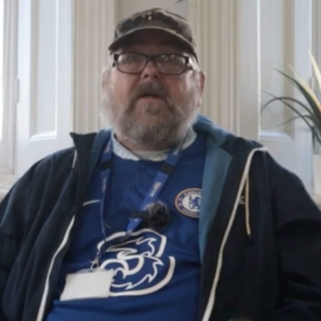 Portrait of Dave, a volunteer in EDP's Together Devon service, in his treasured Chelsea shirt