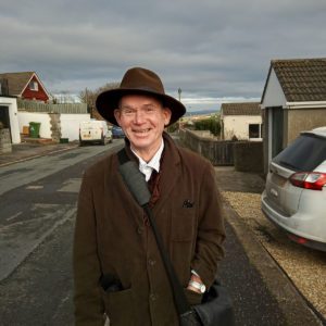 Portrait of Malcolm a volunteer in Devon in his hat and coat in the street