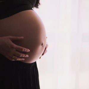 Photo of a bare, pregnant tummy