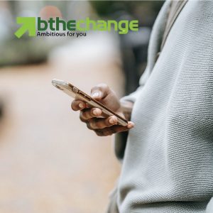 The middle section of the person is visible and they are texting on a phone. Bthechange logo is included in the top left corner