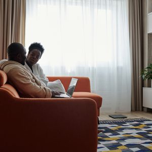 Two people sitting on a sofa having a conversation